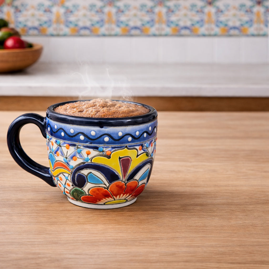Colorful ceramic mug with floral patterns on a wooden surface