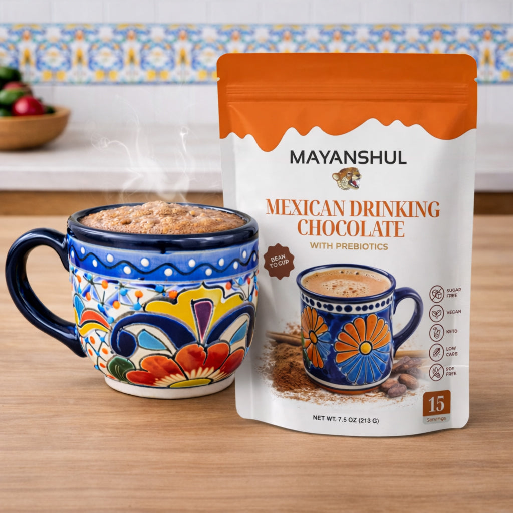Mayanshul Mexican Drinking Chocolate package with a colorful mug on a wooden surface.