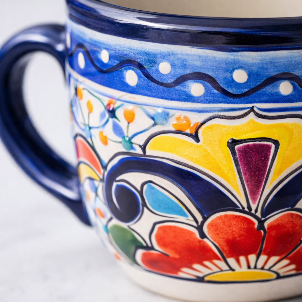 Colorful ceramic mug with floral patterns on a white background