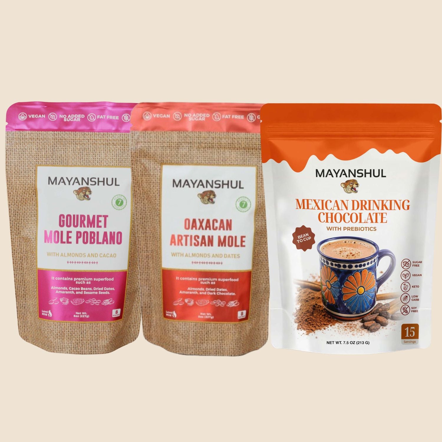 Three packages of Mayanshul gourmet products on a beige background