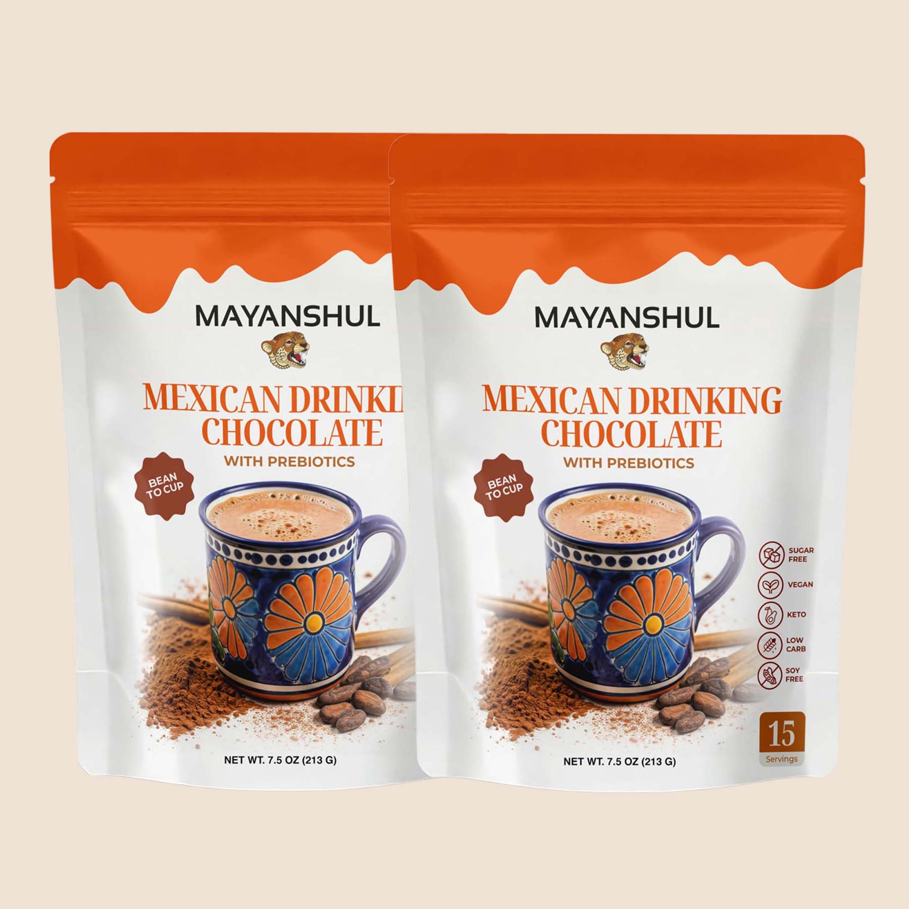 Two packages of Mayanshul Mexican Drinking Chocolate with Prebiotics on a beige background